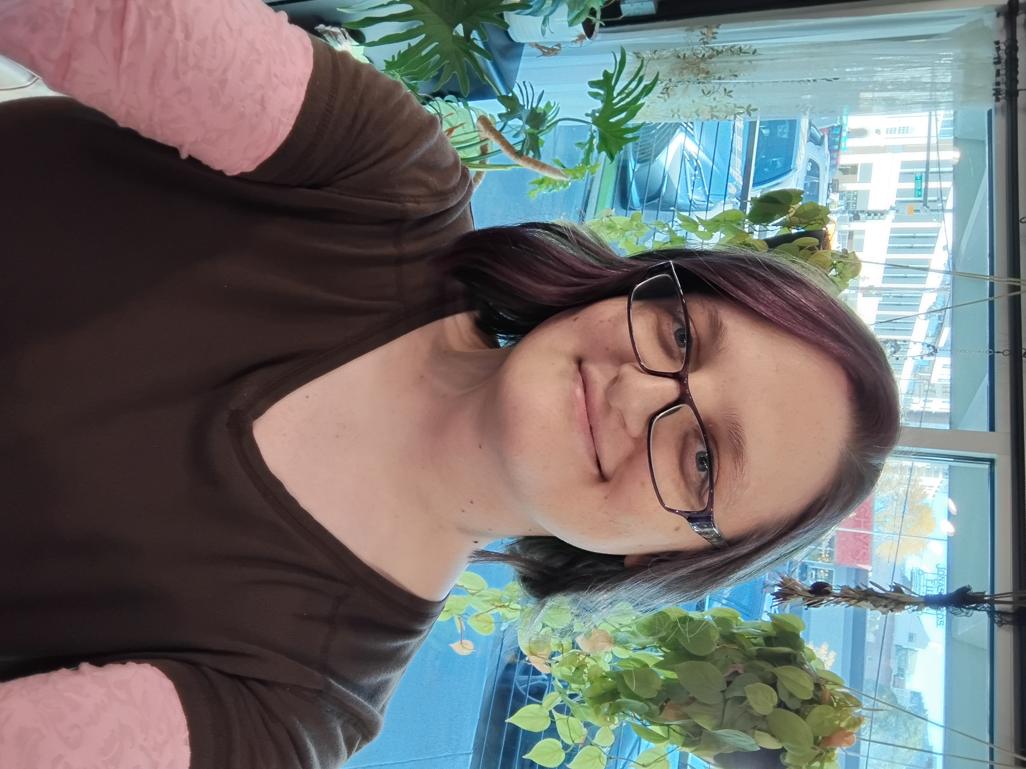 Picture of Josie - a brown haired, blue eyed woman with purple rimmed glasses